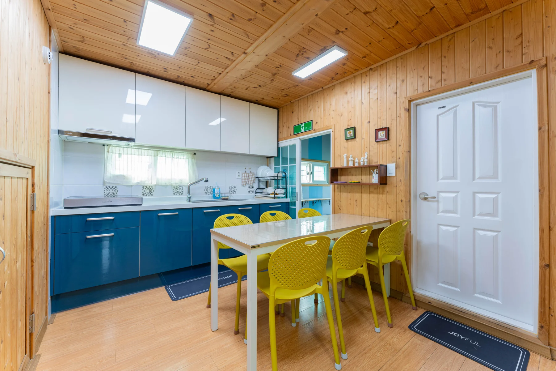 Kitchen with yellow chairs and a dining table