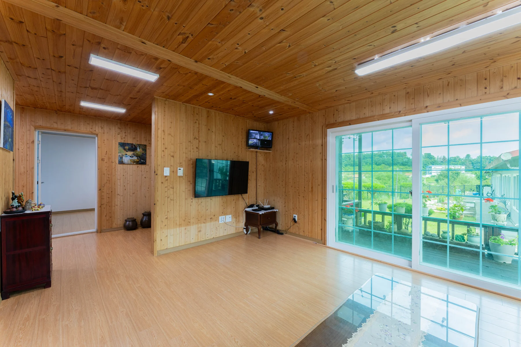 Living room with TV and large windows