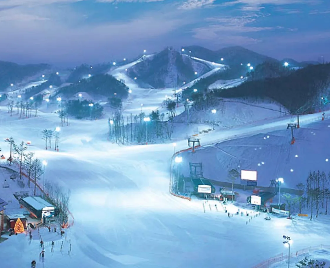 Snowy slopes and night lights at Oak Valley