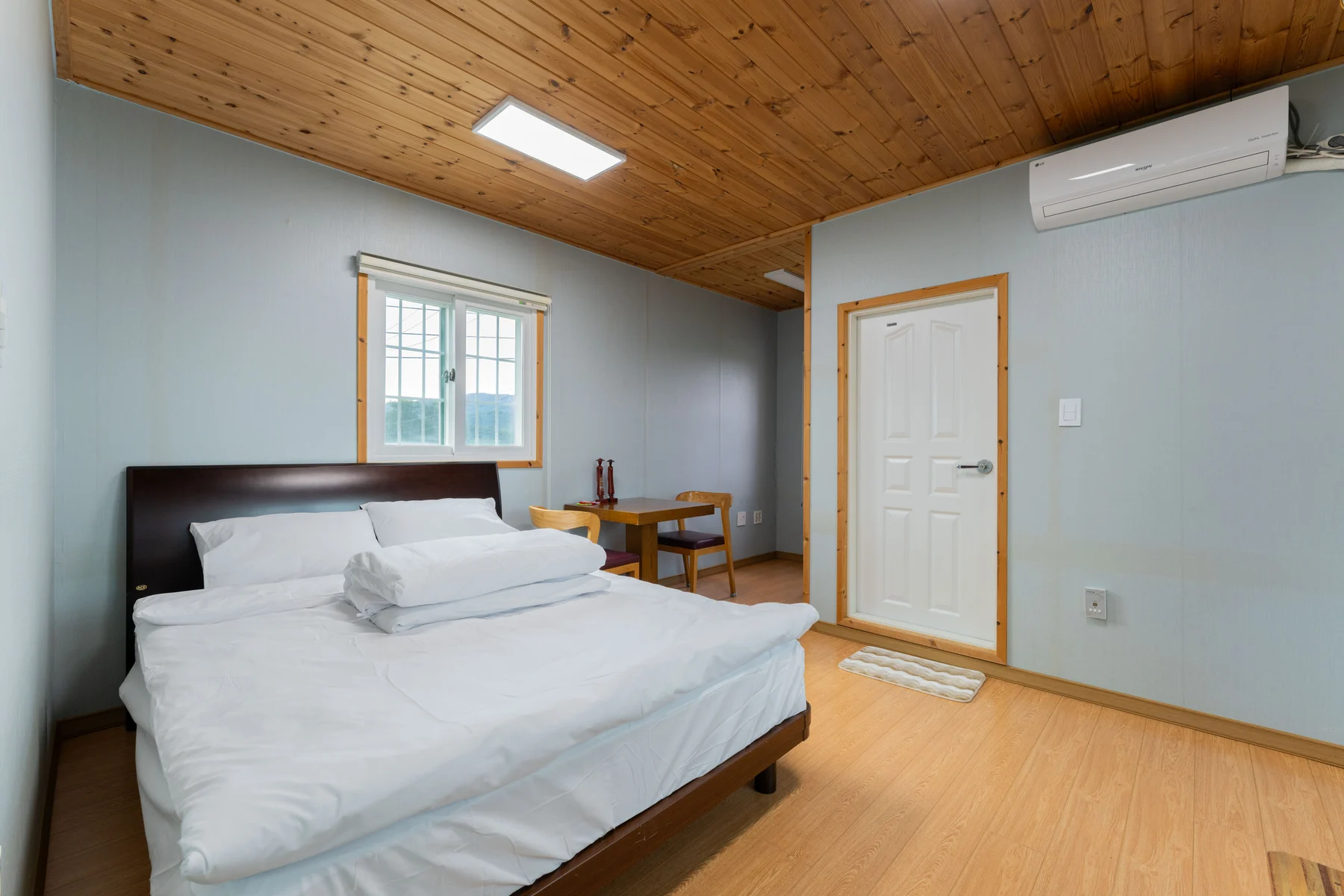 Upstairs bedroom with a bed and table